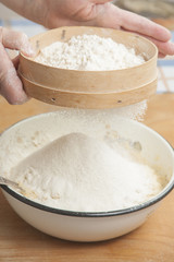 Women's hands preparing flour before baking pie