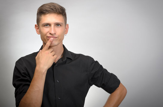 Man thinks finger near mouth