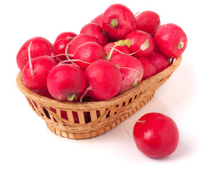 radishes in a wicker basket isolated on white background