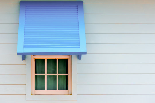 Wood window with blue paravane in natural light