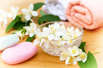 Fototapeta na wymiar Massage towels and jasmine flowers on a wooden background