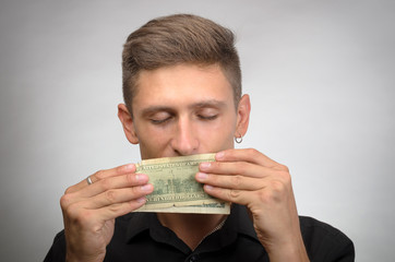 portrait of greedy man holding dollars
