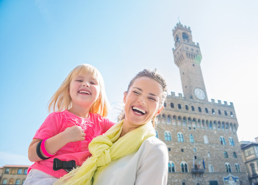 Portrait of happy mother and child near Palazzo Vecchio