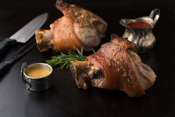 Roasted pork knuckle with mustard, spices and rosemary