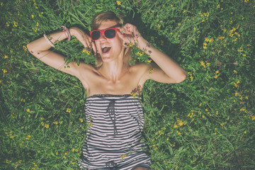 Girl lying on a field filled with flowers.