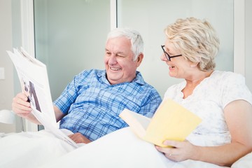 Happy senior couple reading newspaper