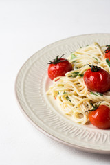 Pasta with cherry tomatoes on the wooden background