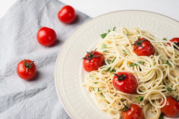 Pasta with cherry tomatoes on the wooden background
