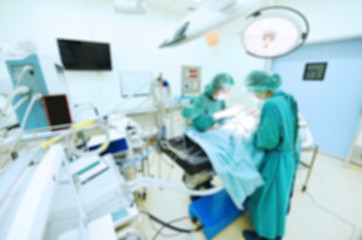 Blur of two veterinarian surgeons in operating room