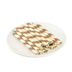 wafer rolls filled with a mixture of chocolate on a white plate.