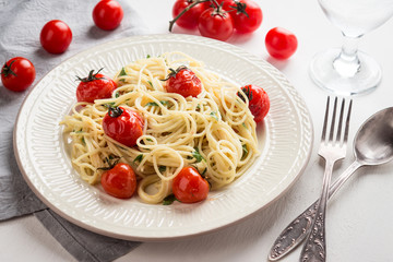 Pasta with cherry tomatoes on the wooden background