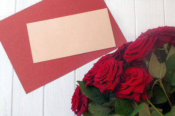 Bouquet of roses flowersnear empty post envelope