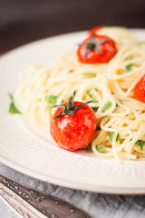 Pasta with cherry tomatoes on the wooden background
