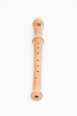 Wooden recorder on white background