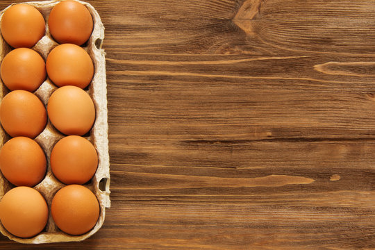 eggs in a tray on a wooden background