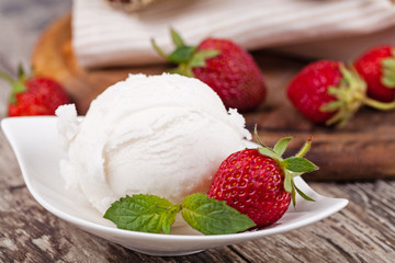 ice cream and strawberries on a wooden table