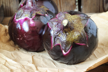 Three mature round eggplants