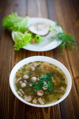 vegetable soup with sausages in a plate