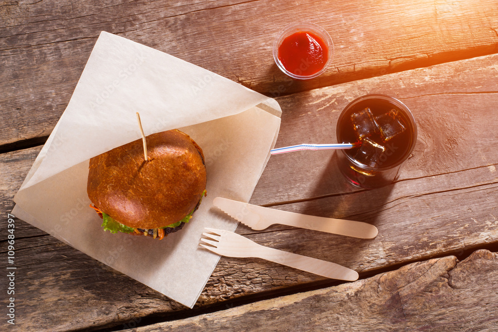 Wall mural burger with cutlery and ketchup. hamburger and glass with cola. traditional burger with special sauc