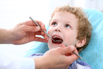 Close up of boy having his teeth examined by a dentist