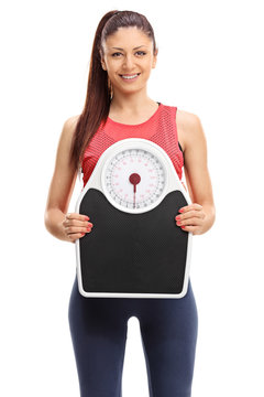Beautiful woman holding a weight scale