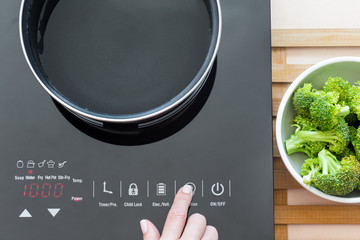 Woman select function on Induction stove