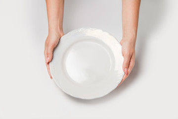 Woman two hands hold a white dish isolated white and top view