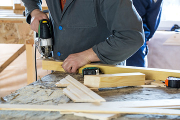 Sawing wooden log by fretsaw