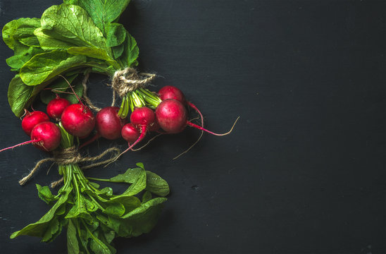 Bunch of radish with leaves on black background