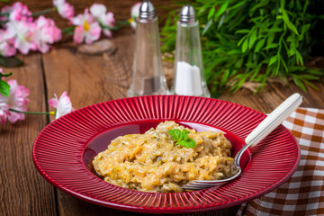 Fried cabbage greens and onion in wooden table.