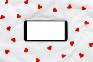 blank screen smartphone on a white soft silk background