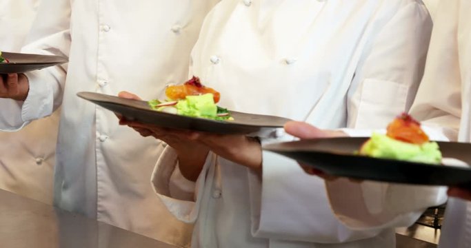 Team of chef presenting their plate