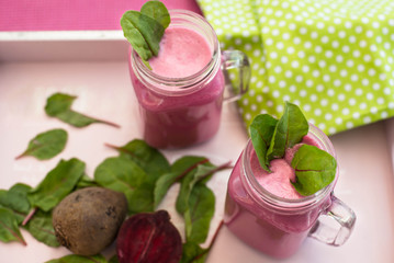 Glass of fresh beetroot juice with bets and leafs . Beetroot smoothie in jar. Pink detox. Eye bird view. Top view.