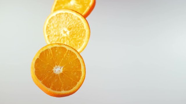 orange slices fly and rotation, slow motion