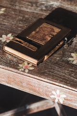 Vintage notebook with leather cover on the wooden table