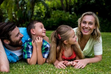 Fototapeta premium Father and children looking at mother in yard