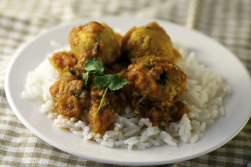 Healthy chicken meatballs in tomato sauce on rice