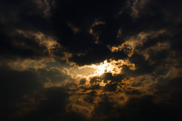 Fototapeta na wymiar Dark colorful stormy cloudy sky background, over sunlight