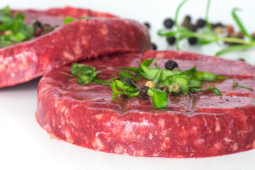 Raw beef hambuger isolated on white background
