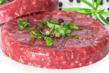 Raw beef hambuger isolated on white background