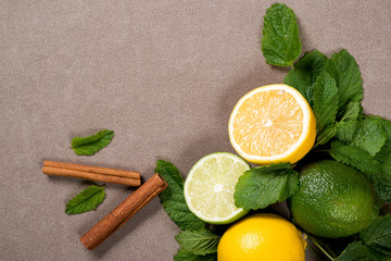 Yellow lemon, lime and green mint leaves on the table. Top view