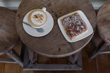 Aroma cappuccino with chocolate croissant on the round vintage w