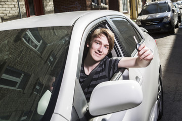 Teenage boy and new driver behind wheel of his car