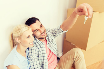 couple with key and boxes moving to new home