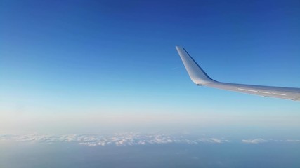 View of an aircraft wing during flight at sunset