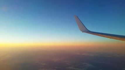 View of an aircraft wing during flight at sunset