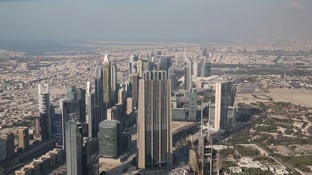 View on financial centre in Dubai downtown, United Arab Emirates. View from 124th floor of Burj Khalifa skyscraper in Dubai, currently the tallest structure in the world. At the top Burj Khalifa