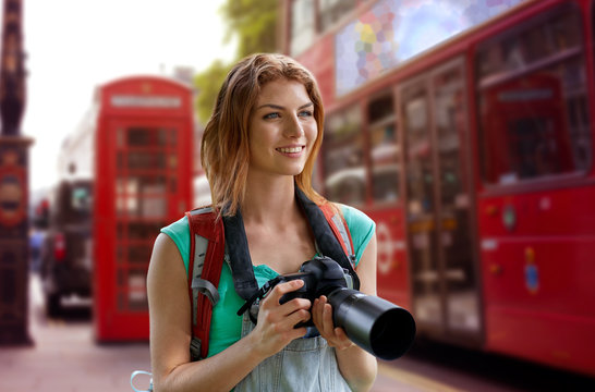 woman with backpack and camera over london city