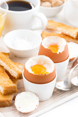 delicious breakfast with boiled eggs and crispy toasts, vertical