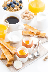 delicious breakfast with soft boiled eggs and crispy toasts